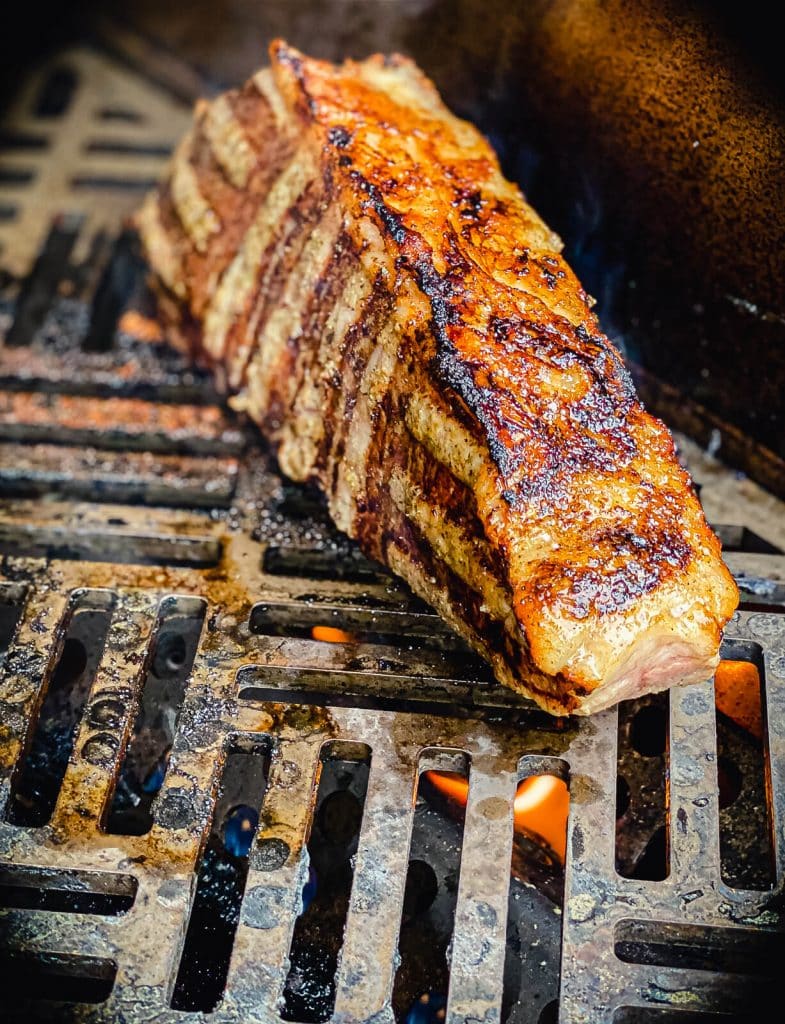 strip steak cooking on the gas grill head