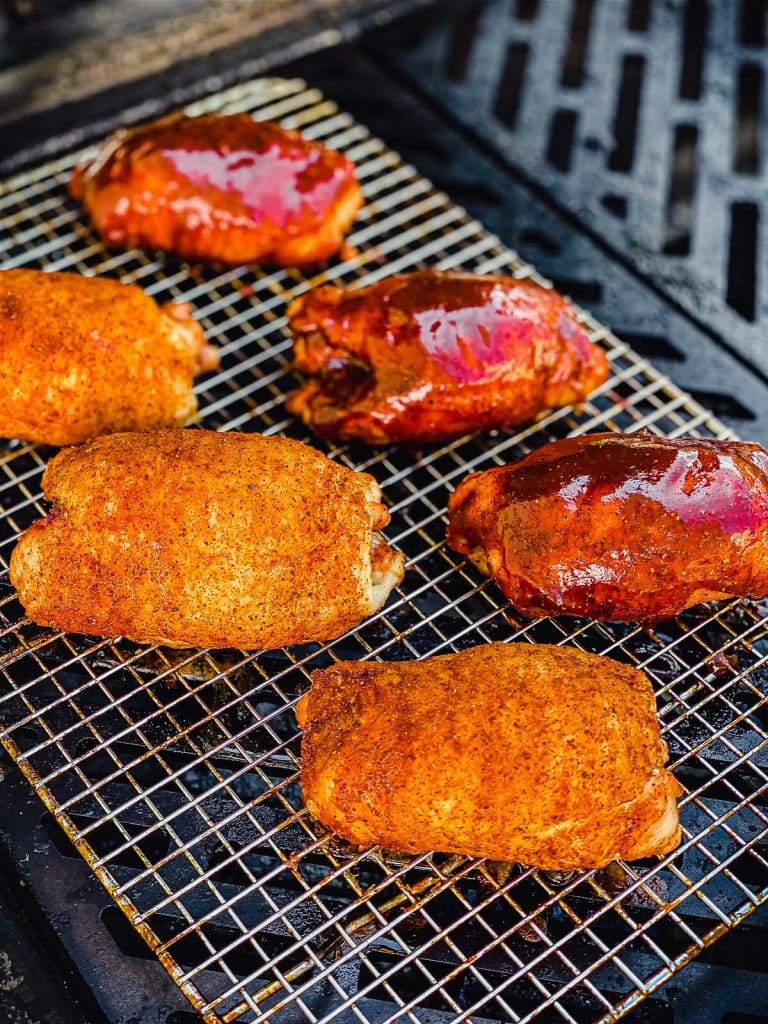 smoked chicken thighs with bbq sauce on the grill