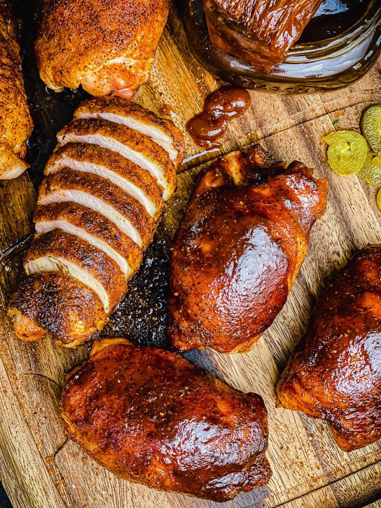 smoked chicken thighs on a wood platter