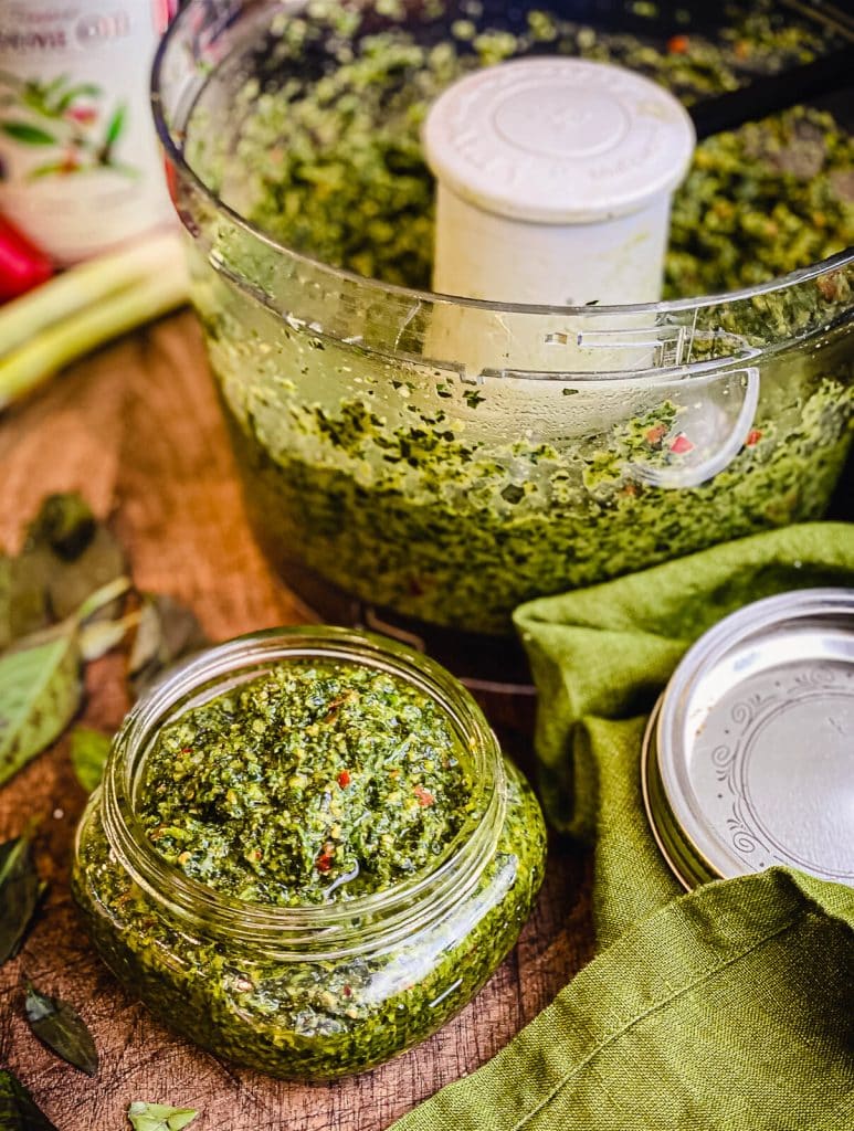 Thai basil pesto in a jar next to a food processor