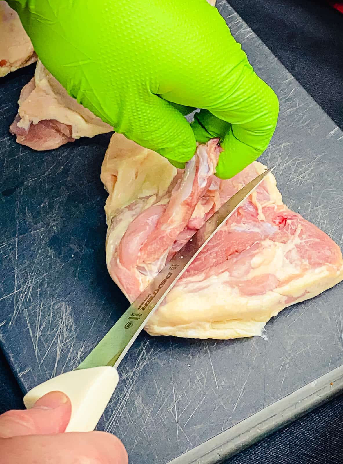 bone being removed from a chicken thigh
