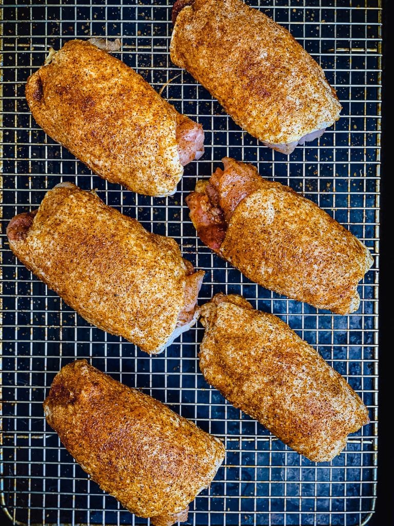 seasoned chicken thighs on a wire rack