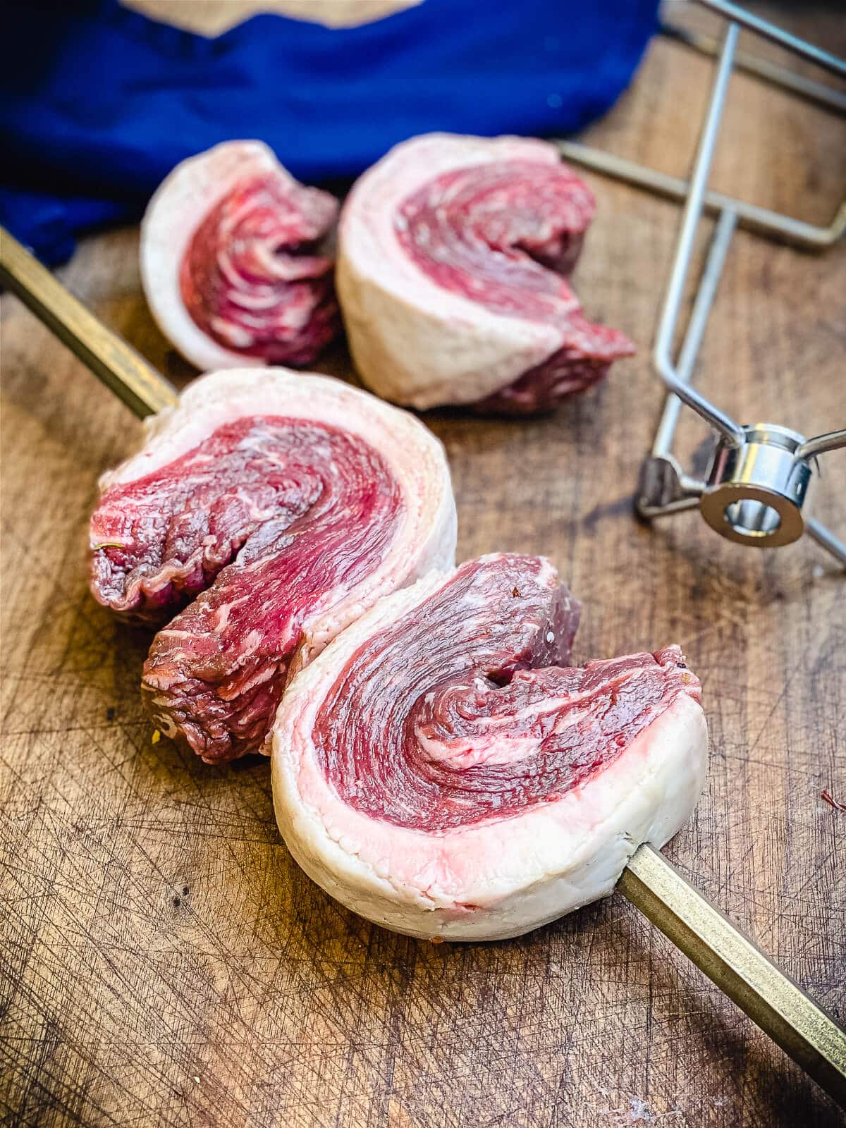 picanha being put on a rotisserie spit