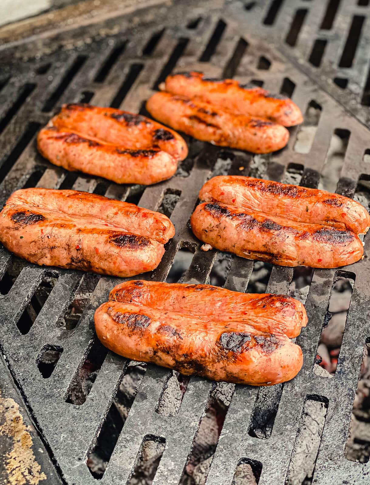 chorizo being grilled over hot coals