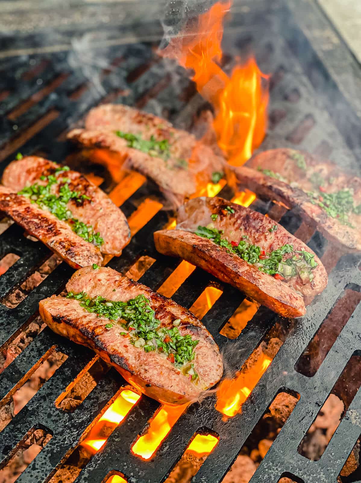 chorizo dressed with chimichurri on a hot grill