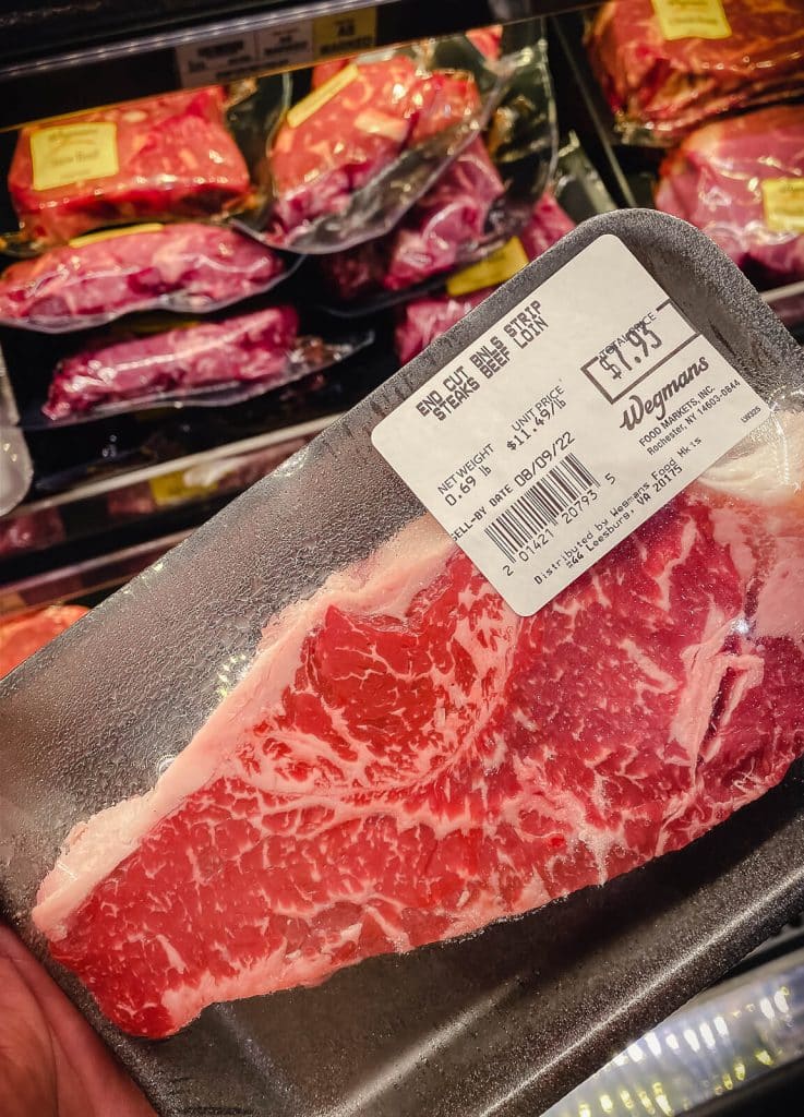 end cut New York strip steak in packaging at the butcher