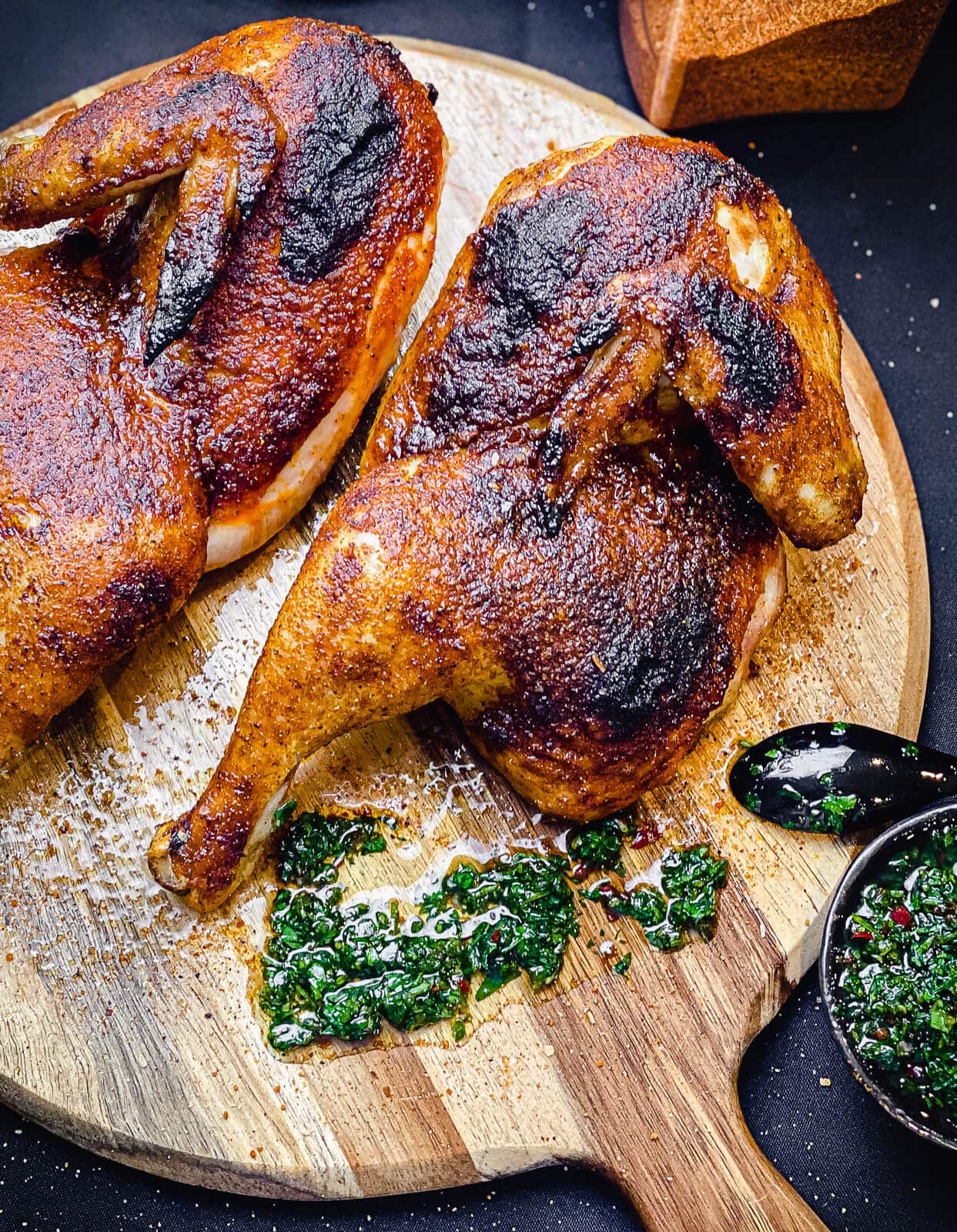 grilled chicken halves on a cutting board