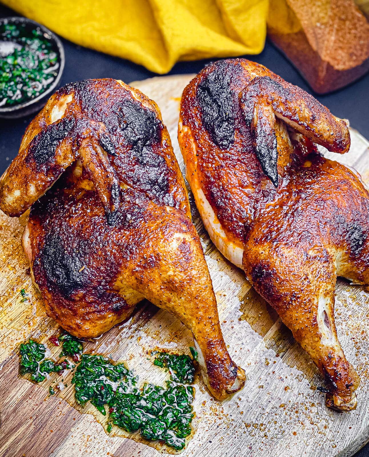 https://www.grillseeker.com/wp-content/uploads/2022/08/grilled-chicken-halves-with-chimichurri-on-cutting-board.jpg