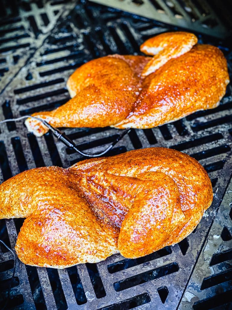 chicken halves on a gas grill
