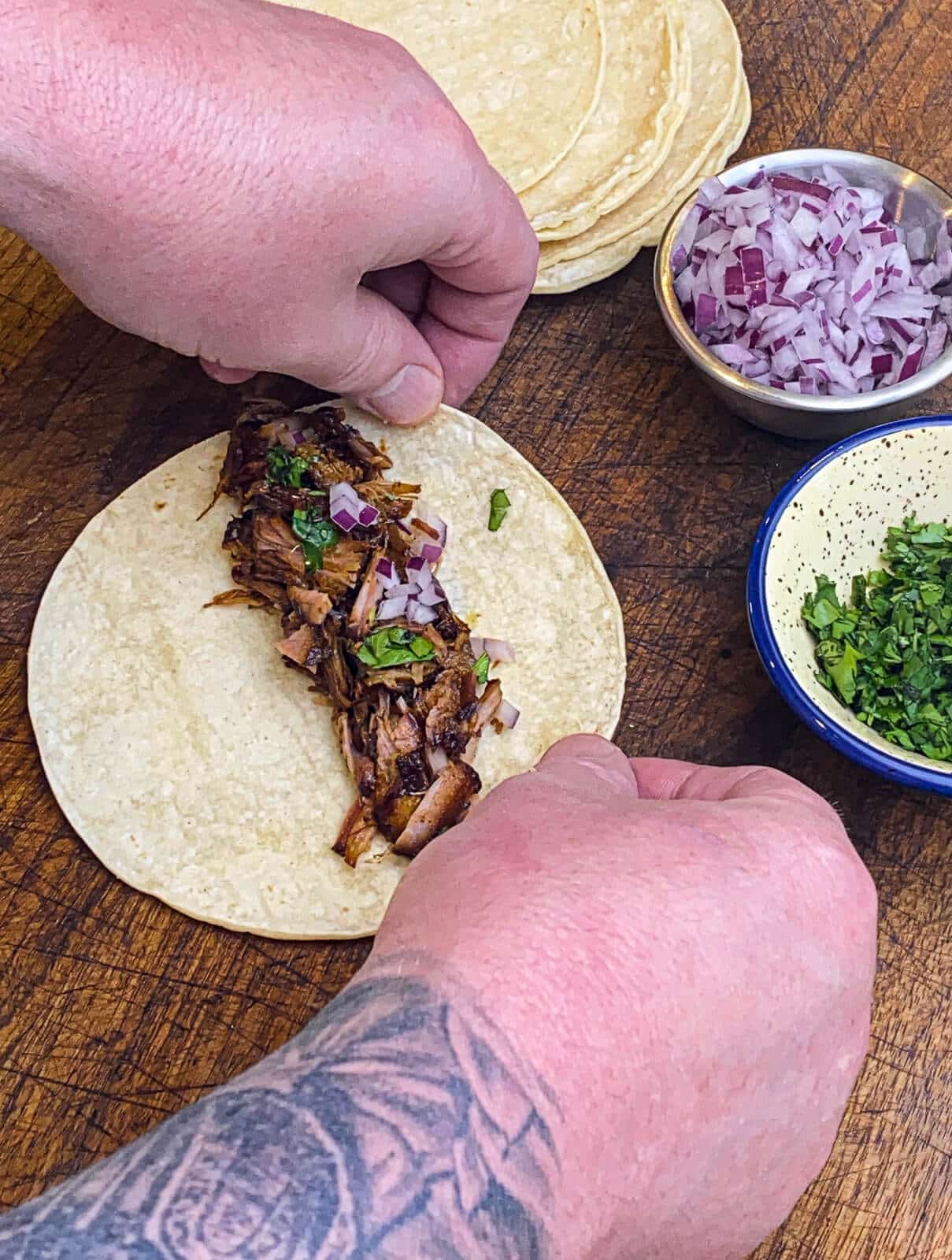 assembling taquitos on a cutting board