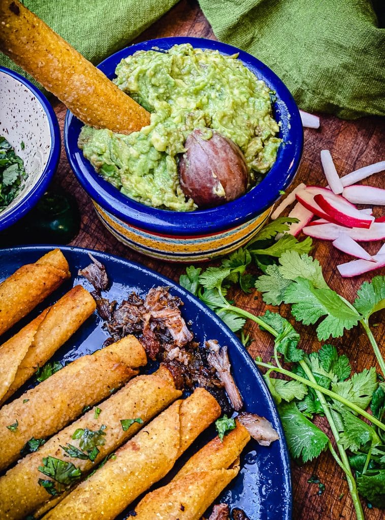 leftover carnitas taquitos in guacamole