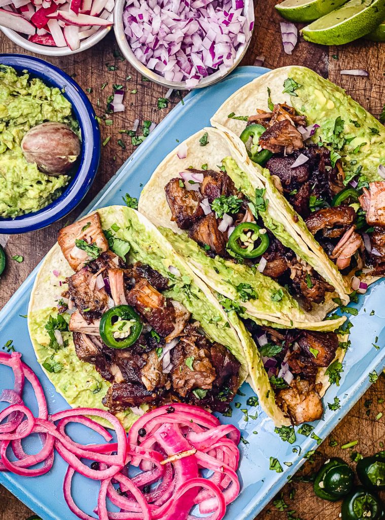 pork carnitas tacos on a plate with guacamole