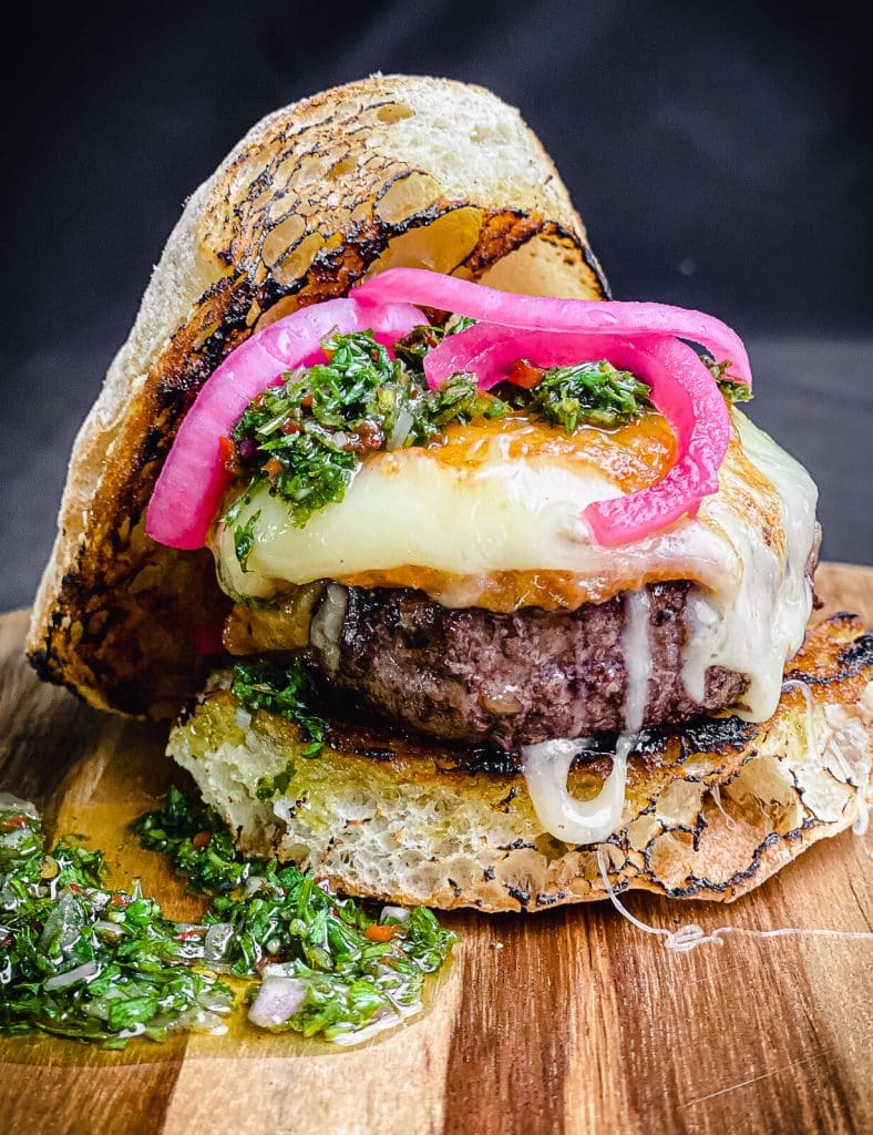 provoleta burger with chimichurri and pickled red onions
