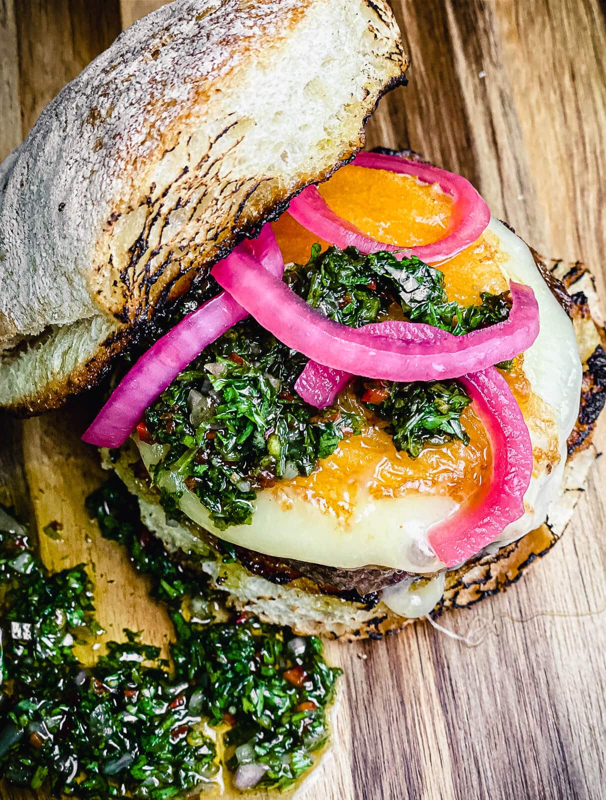 provoleta burger with pickled red onions