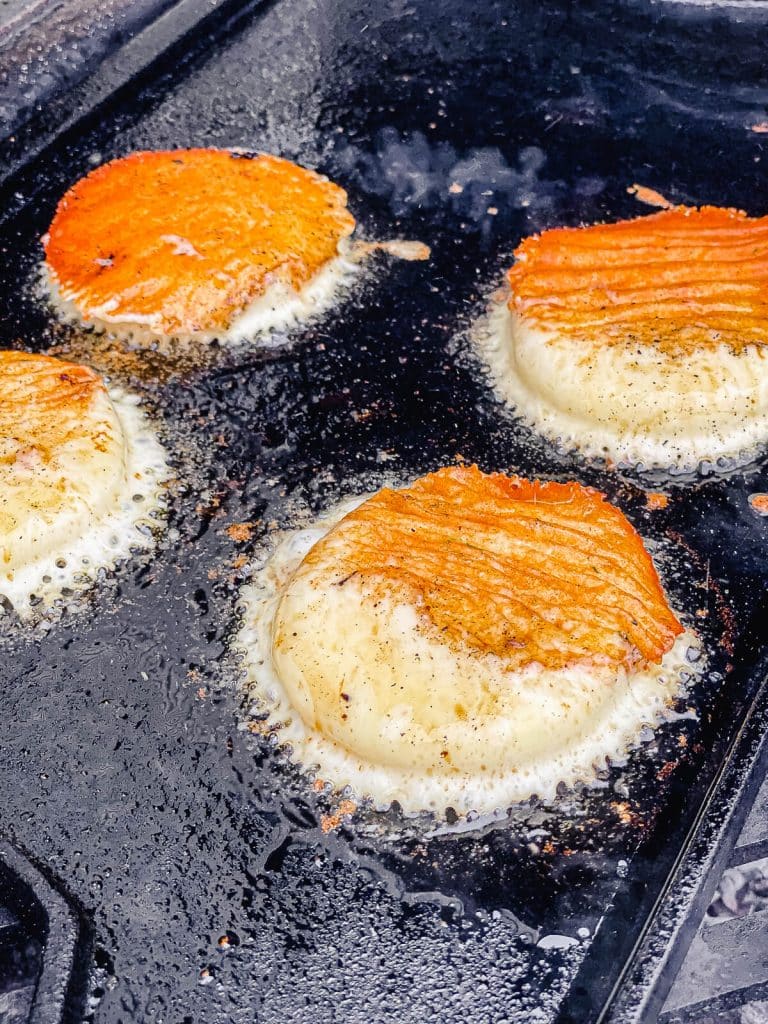provolone cheese frying on a skillet