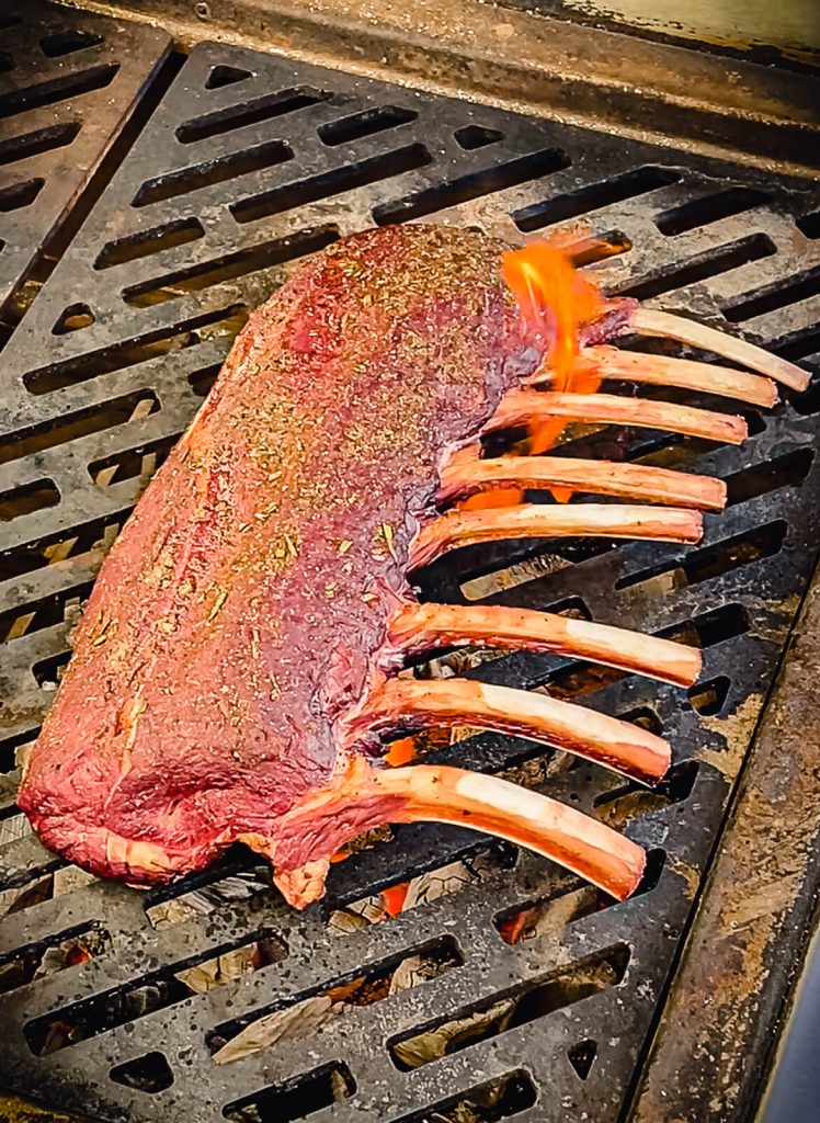 rack of venison being seared on a grill