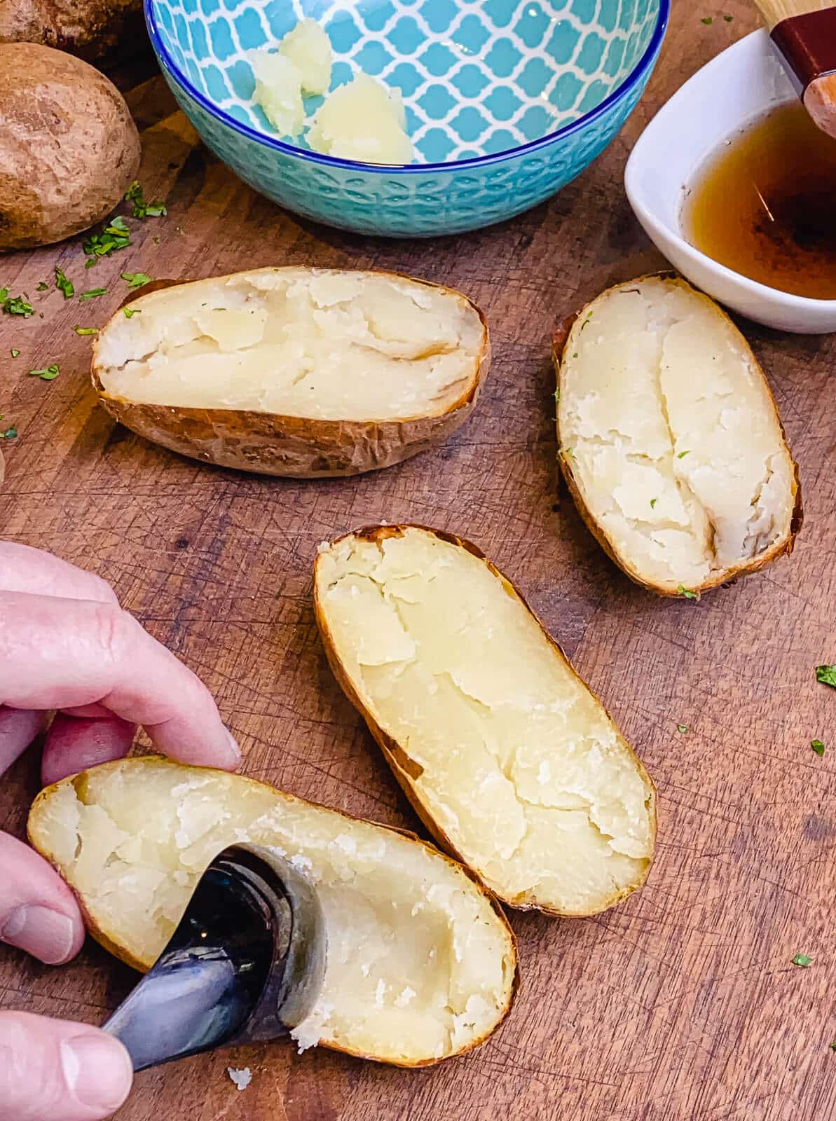 scooping out potato with a spoon