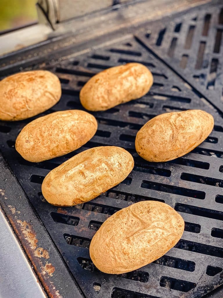 russet potatoes baking on a grill