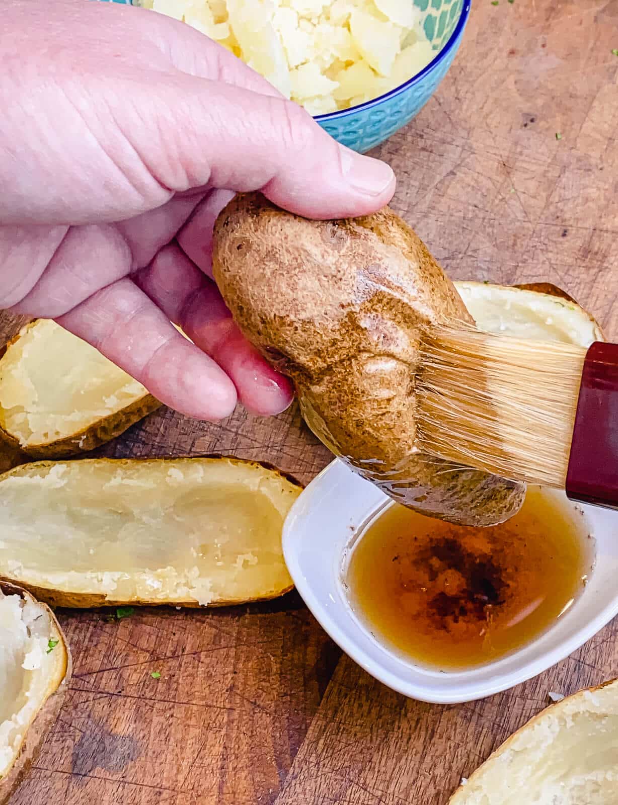 basting a potato with rendered bacon fat