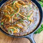 cube steaks in a cast iron pan