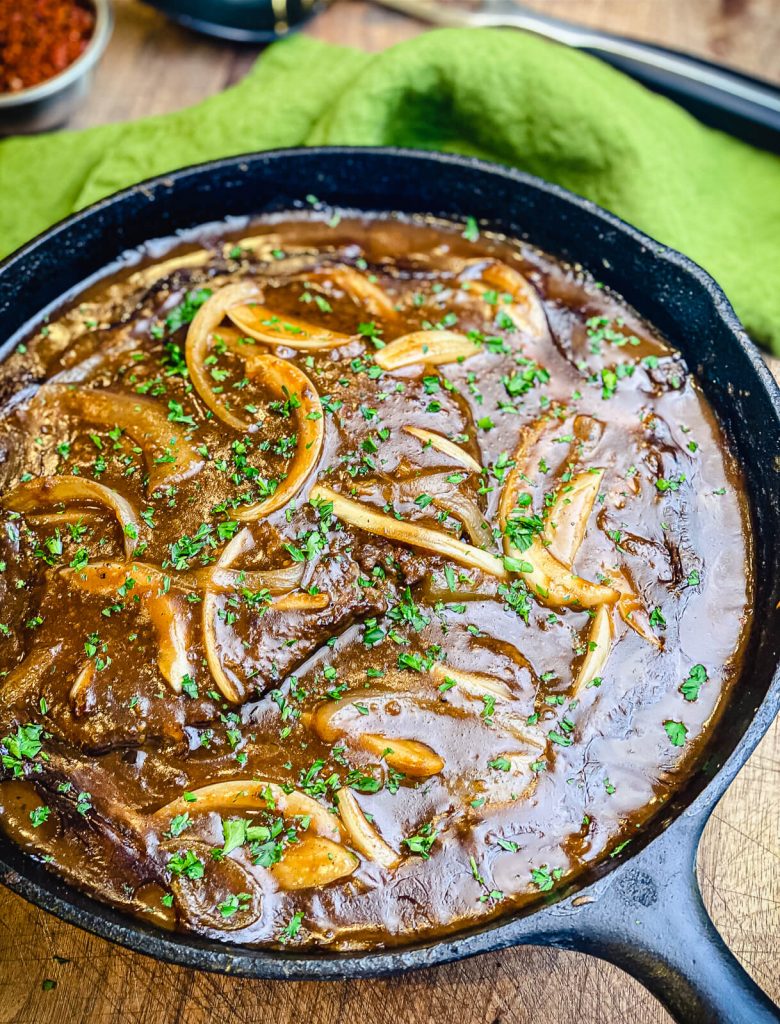 cast iron pan of cubed steak and gravy