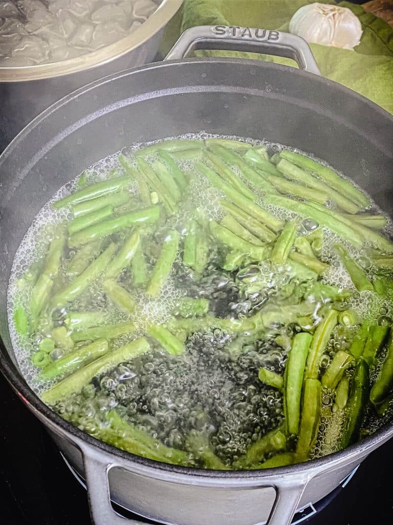 green beans boiling in a pot of water