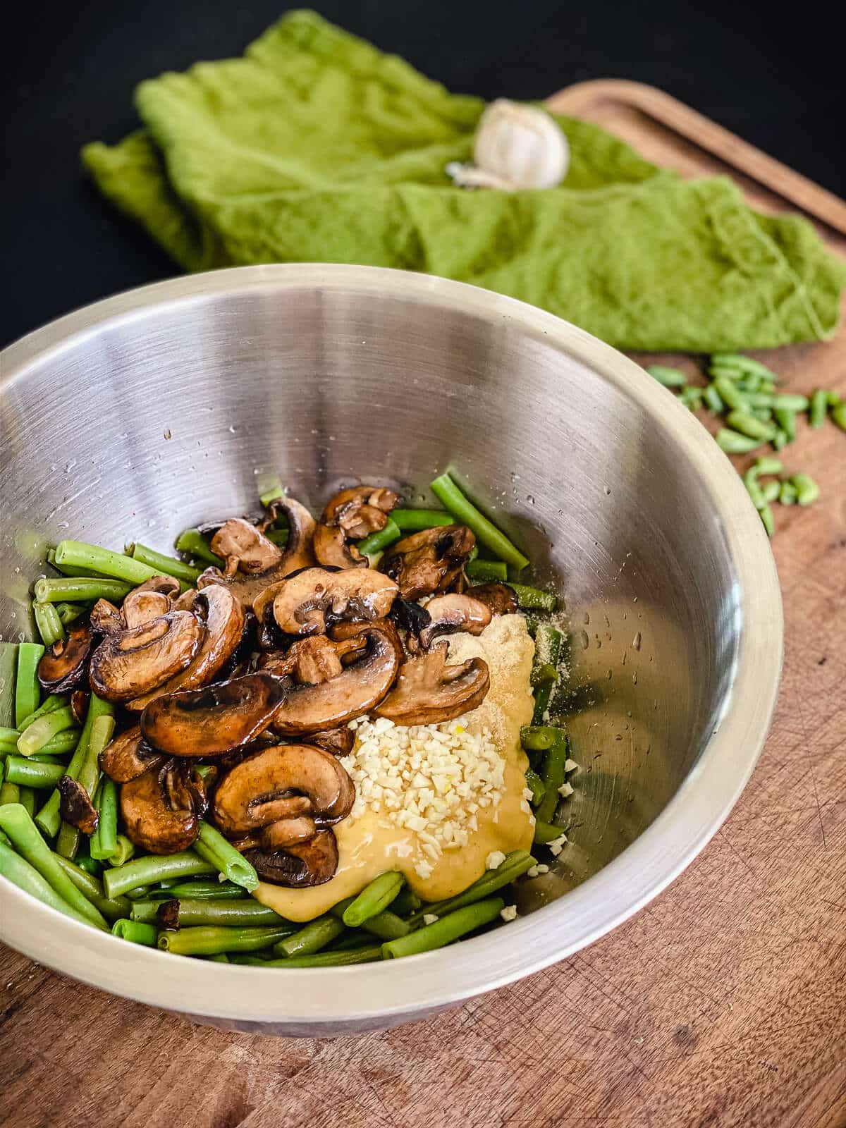 green beans in a mixing bowl with mushrooms