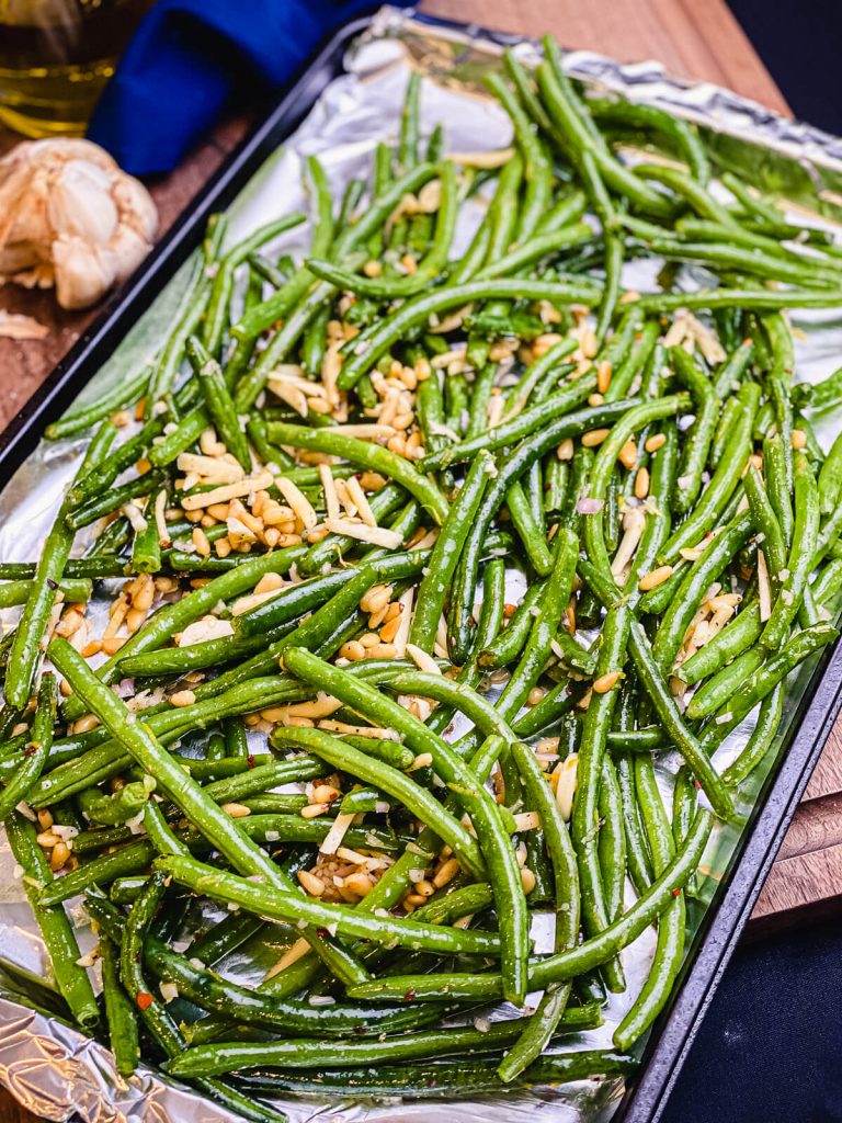 baking sheet of green beans ready to be roasted