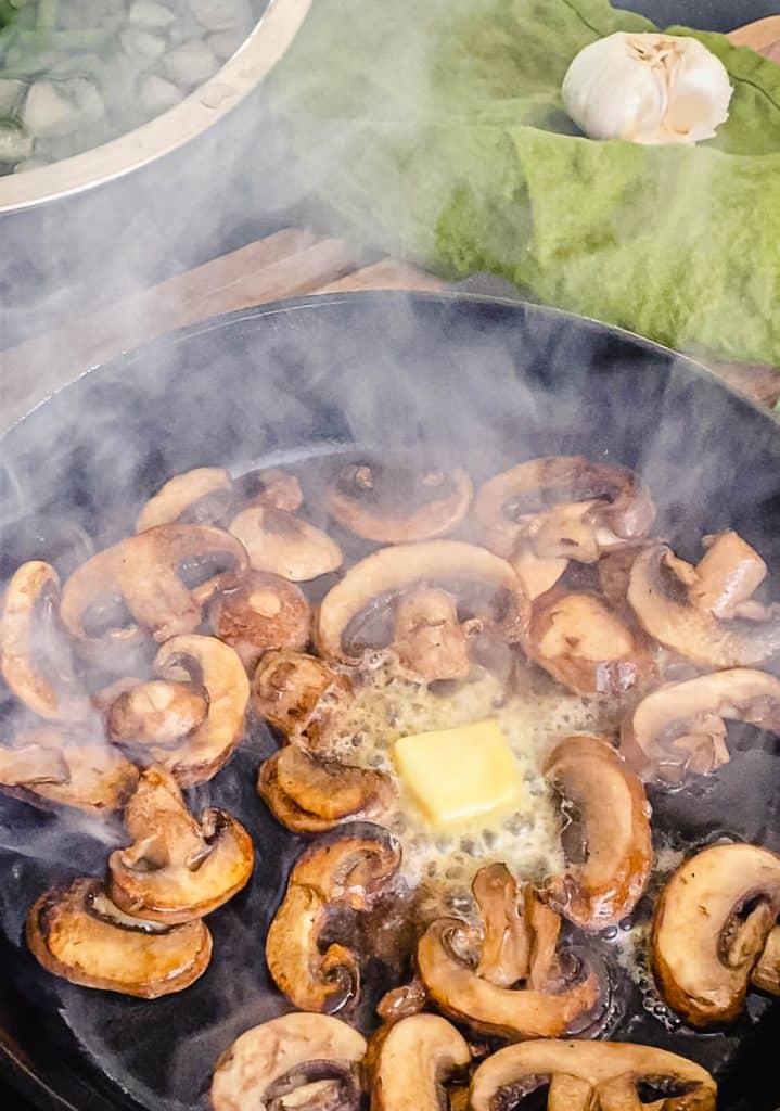 mushrooms in a cast iron pan with butter
