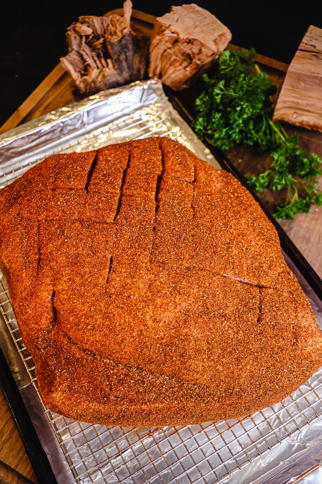 seasoned pork shoulder on a cooling rack