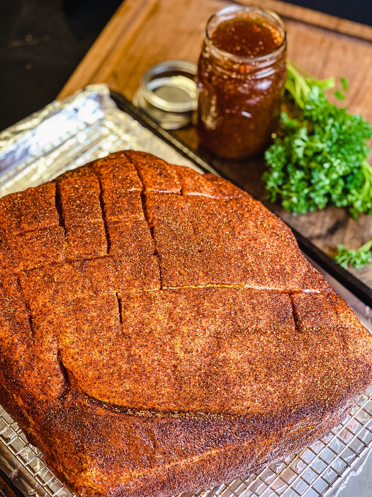 seasoned pork butt on a cooling rack