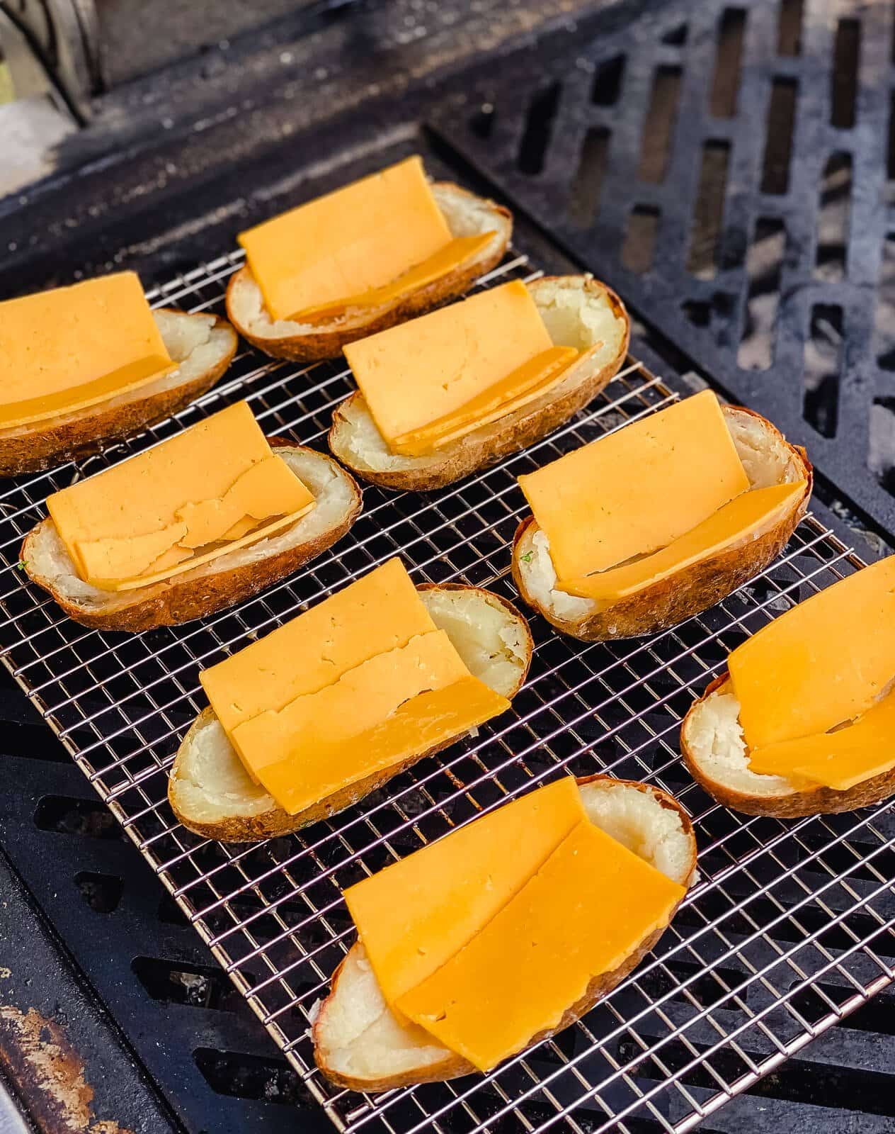 potatoes on a grill with cheese