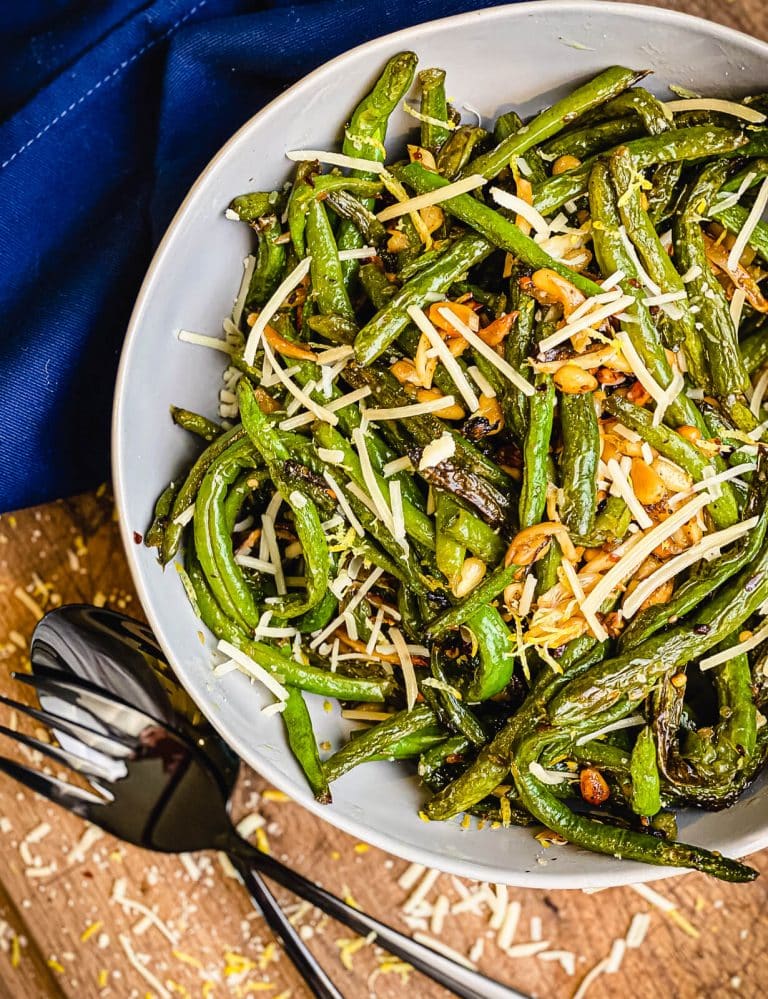 bowl of roasted green beans with pine nuts