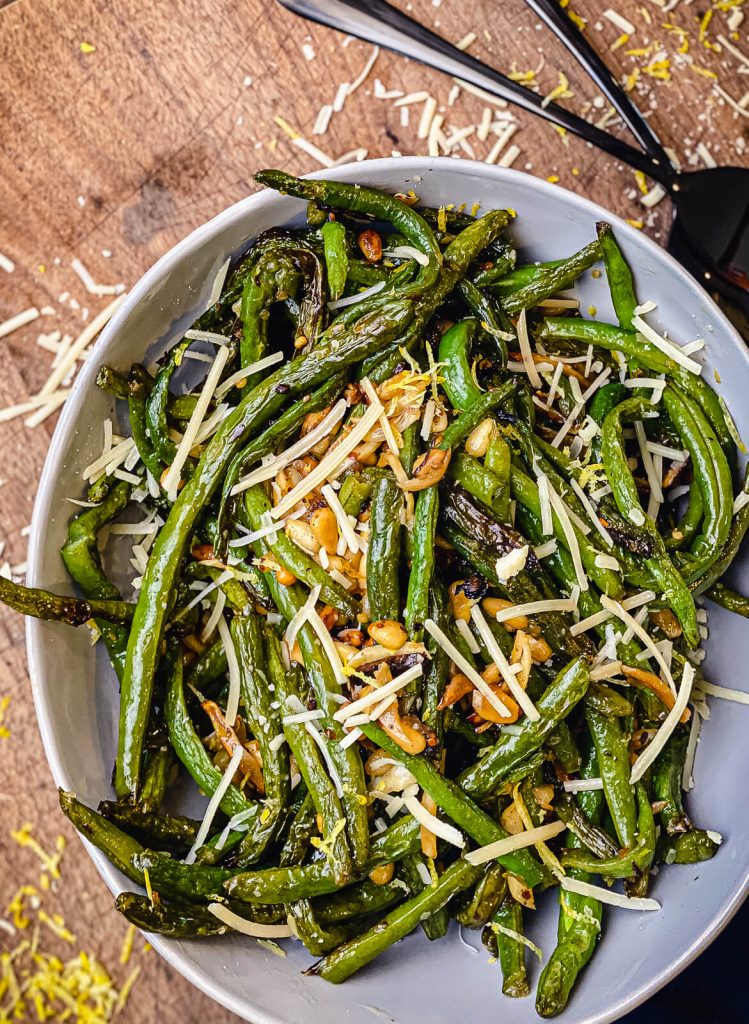 bowl of green beans with pine nuts and garlic