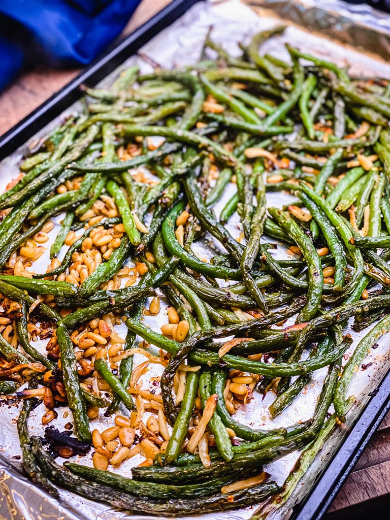 cooked green beans on a baking sheet