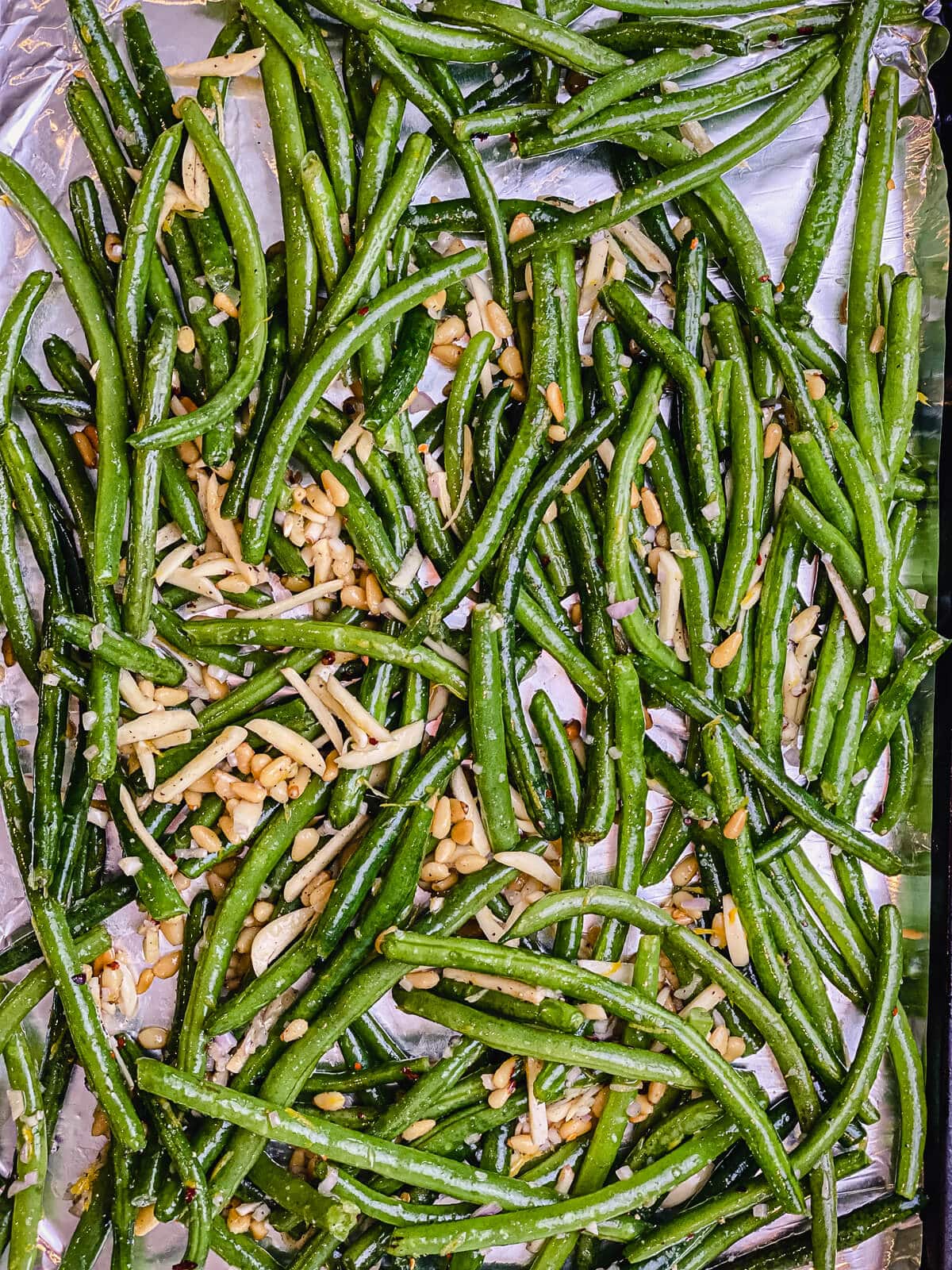 baking sheet of green beans and pine nuts