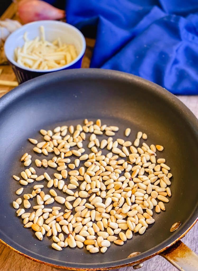 toasted pine nuts in a non-stick pan