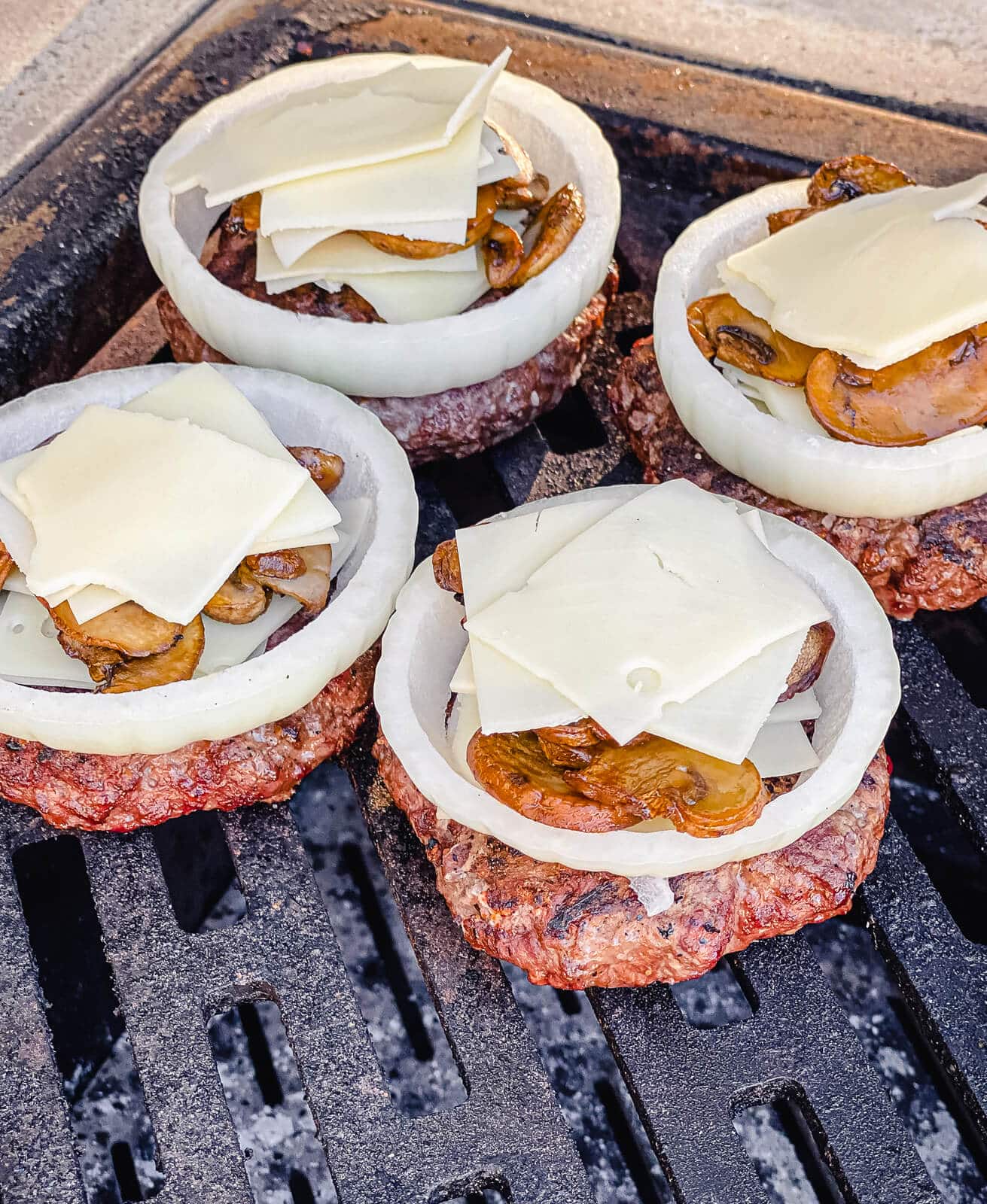 venison burgers topped with cheese and mushrooms