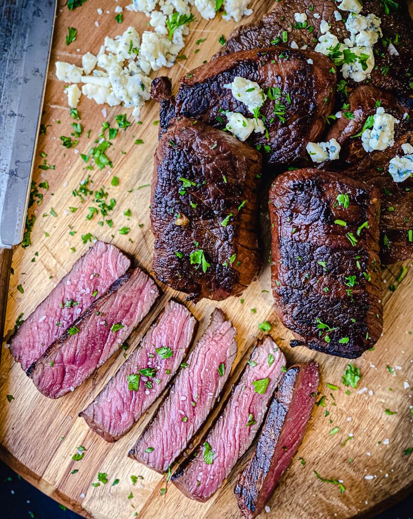 sliced venison steaks on a cutting board