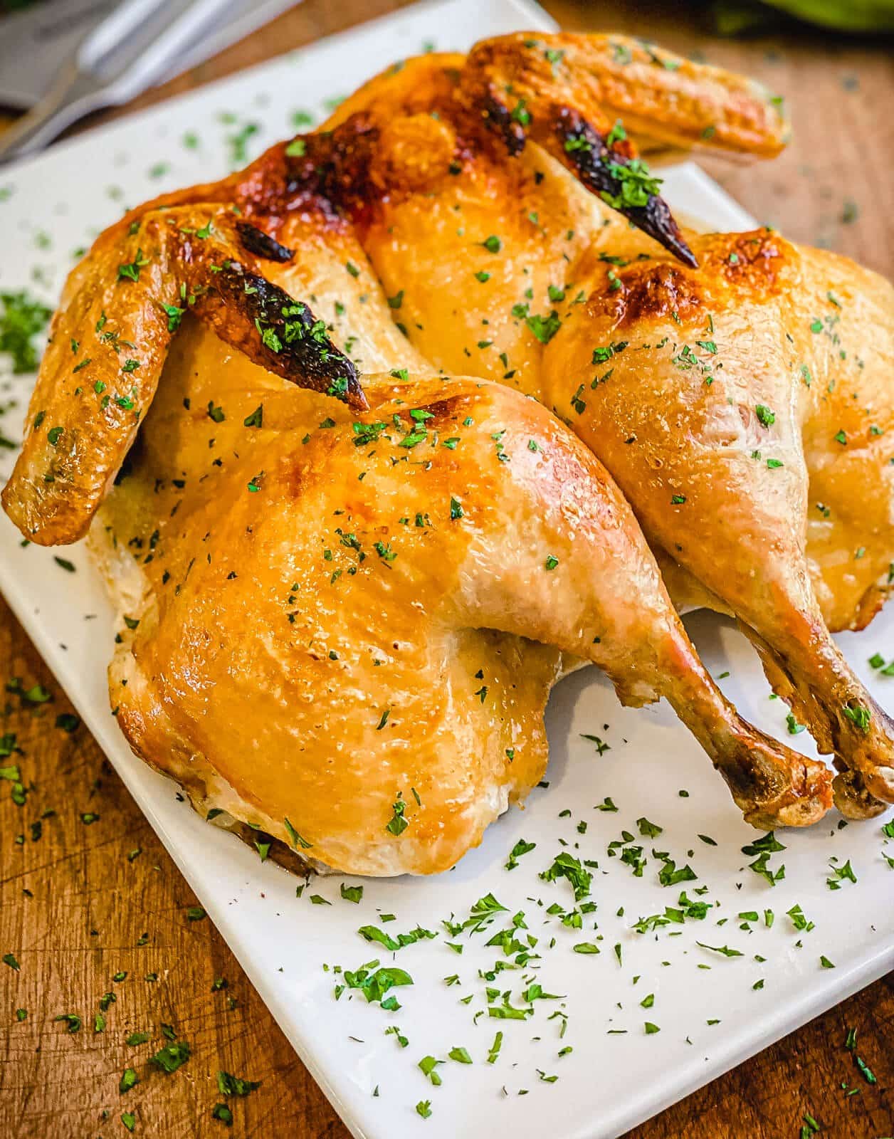 brined whole roasted chicken on a platter