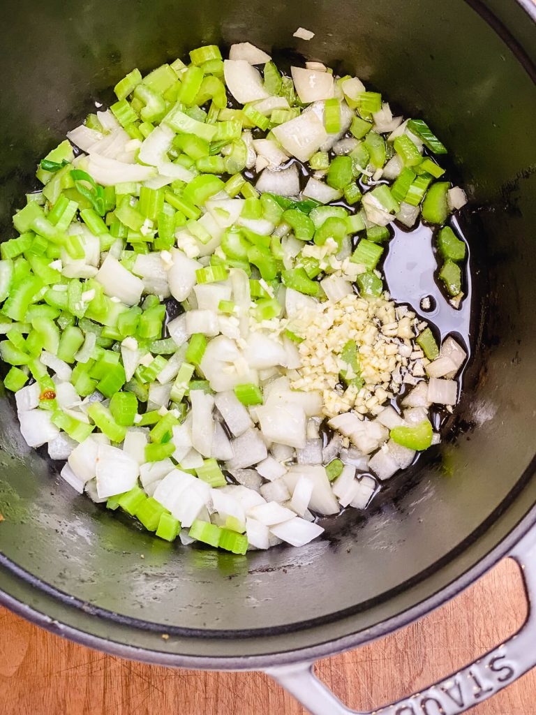 celery and onions in a dutch oven for vegetable soup