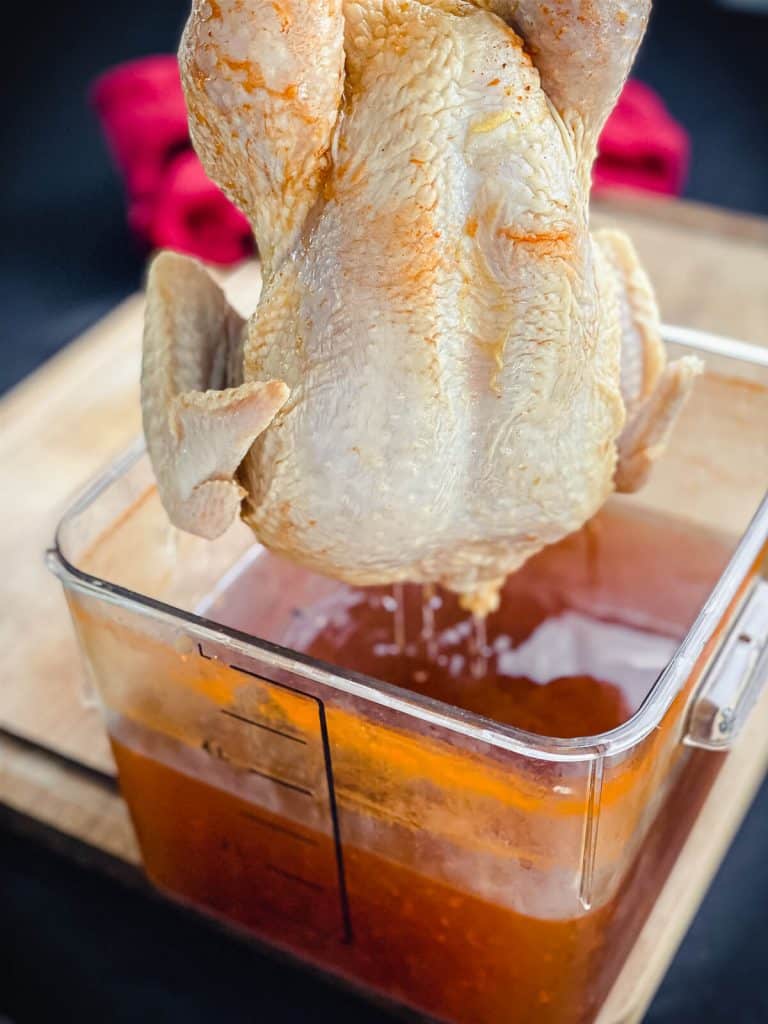 chicken being taken out of brine