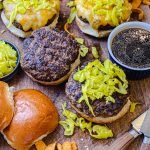 mississippi pot roast burgers on a wooden tray with knives