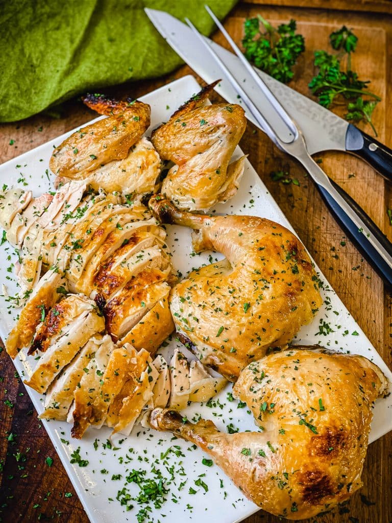 carved brined chicken on a tray