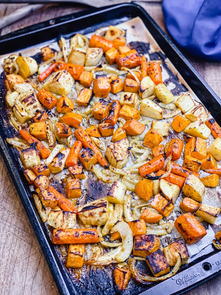 root vegetables roasted and sitting on a baking sheet