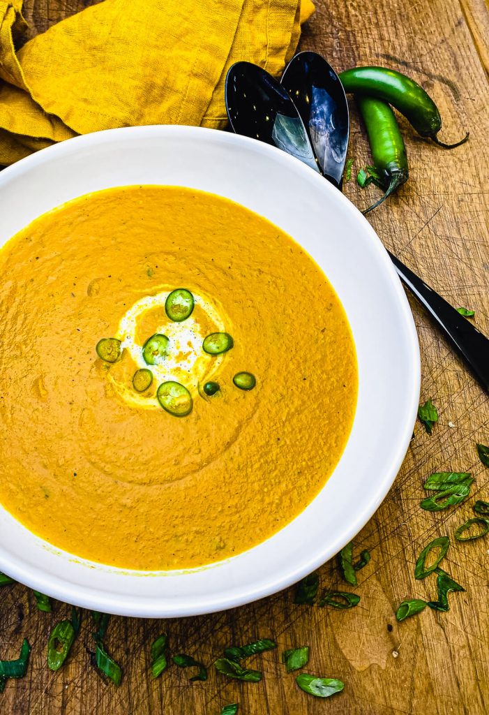 roasted vegetable soup in a bowl with peppers