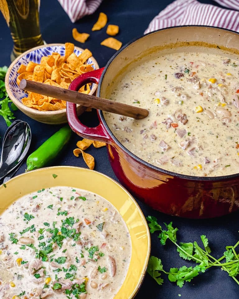 bowl of smoked chicken chili with pot of chili