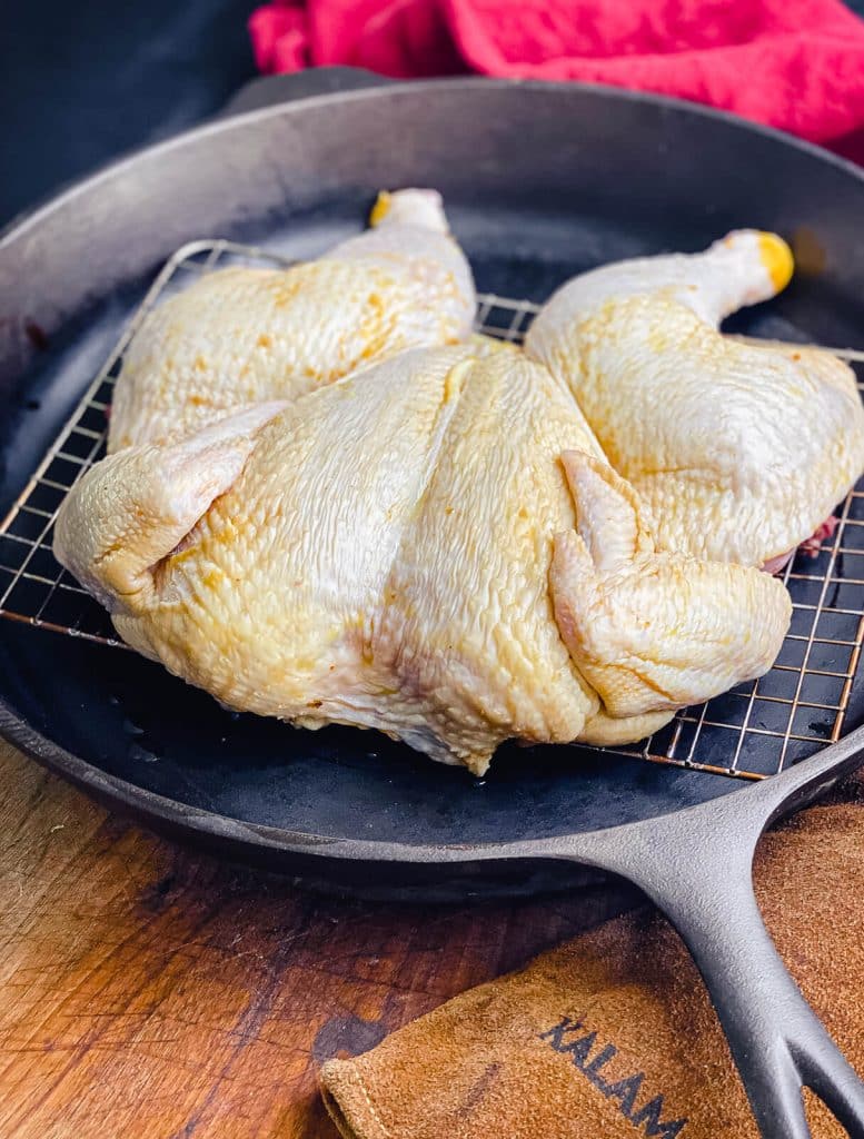 spatchcock chicken in a cast iron pan