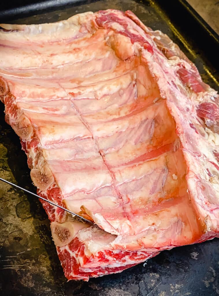 membrane being removed from beef ribs