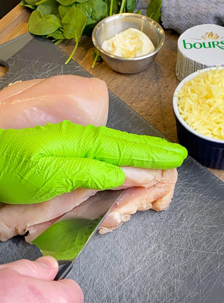 slicing a pocket in a chicken breast for stuffed chicken breast